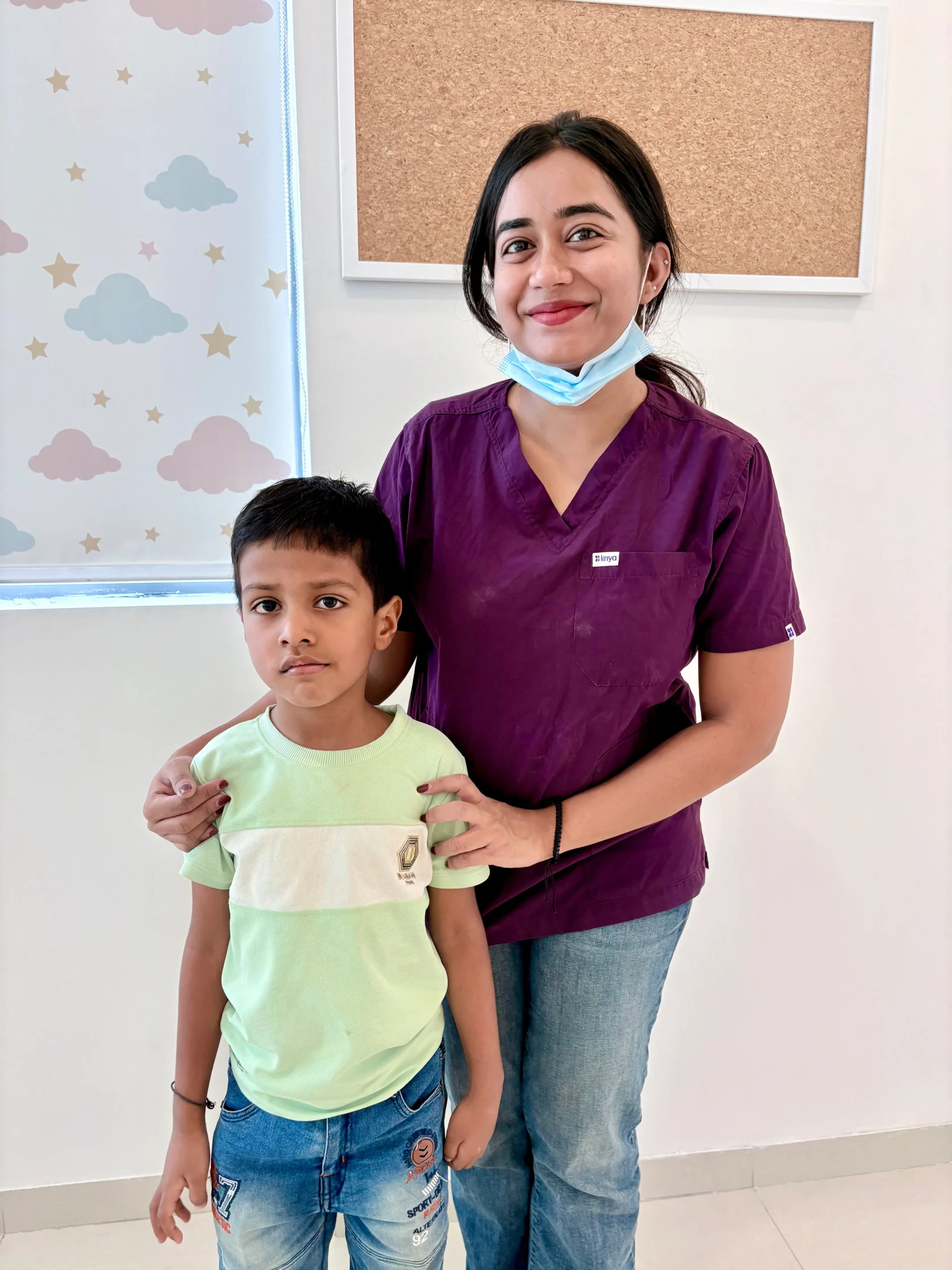 Pediatric dentist with a child patient at Tiny Bites Dental Studio
