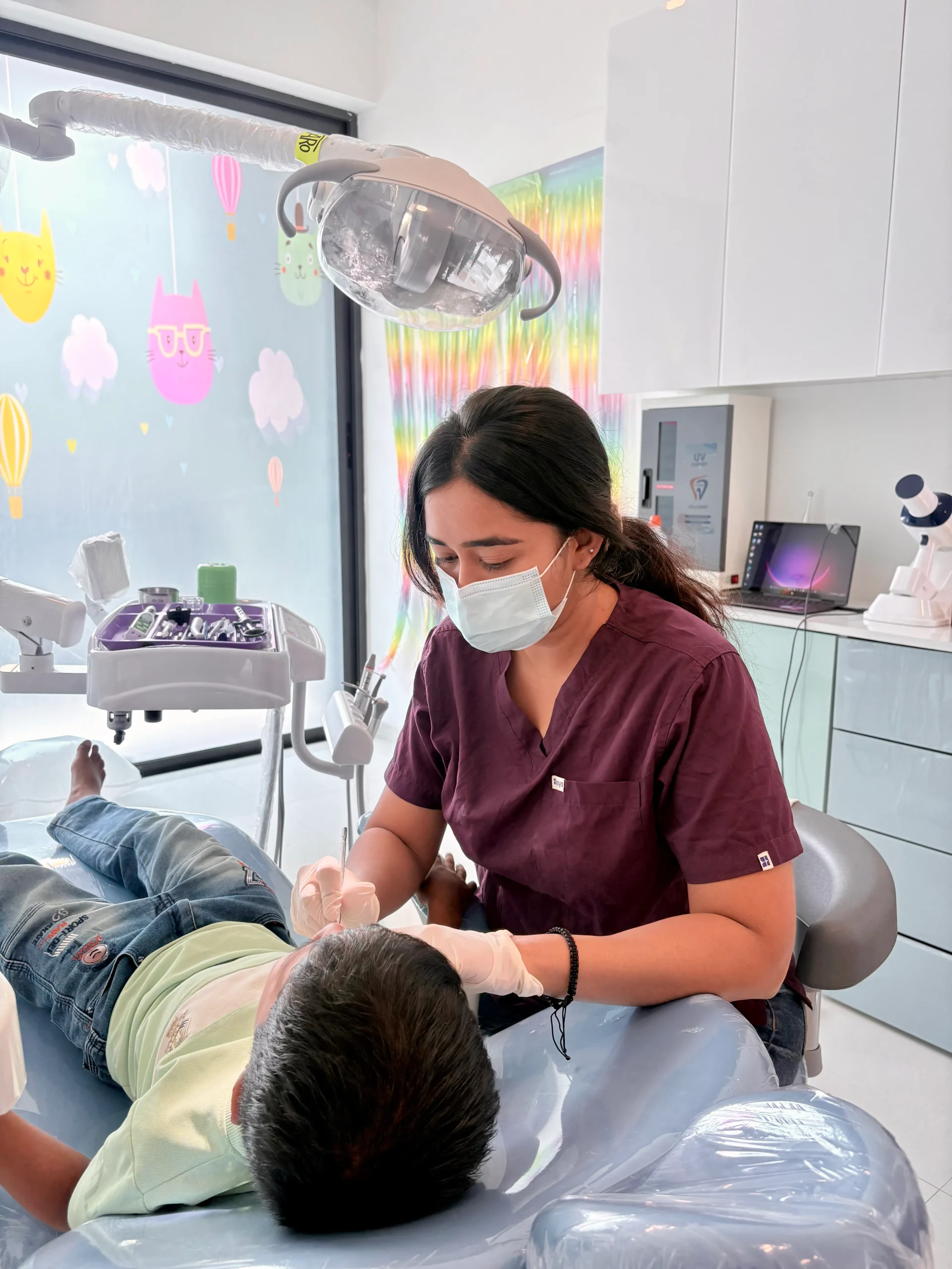 Pediatric dentist with children and parents at Tiny Bites Dental Studio